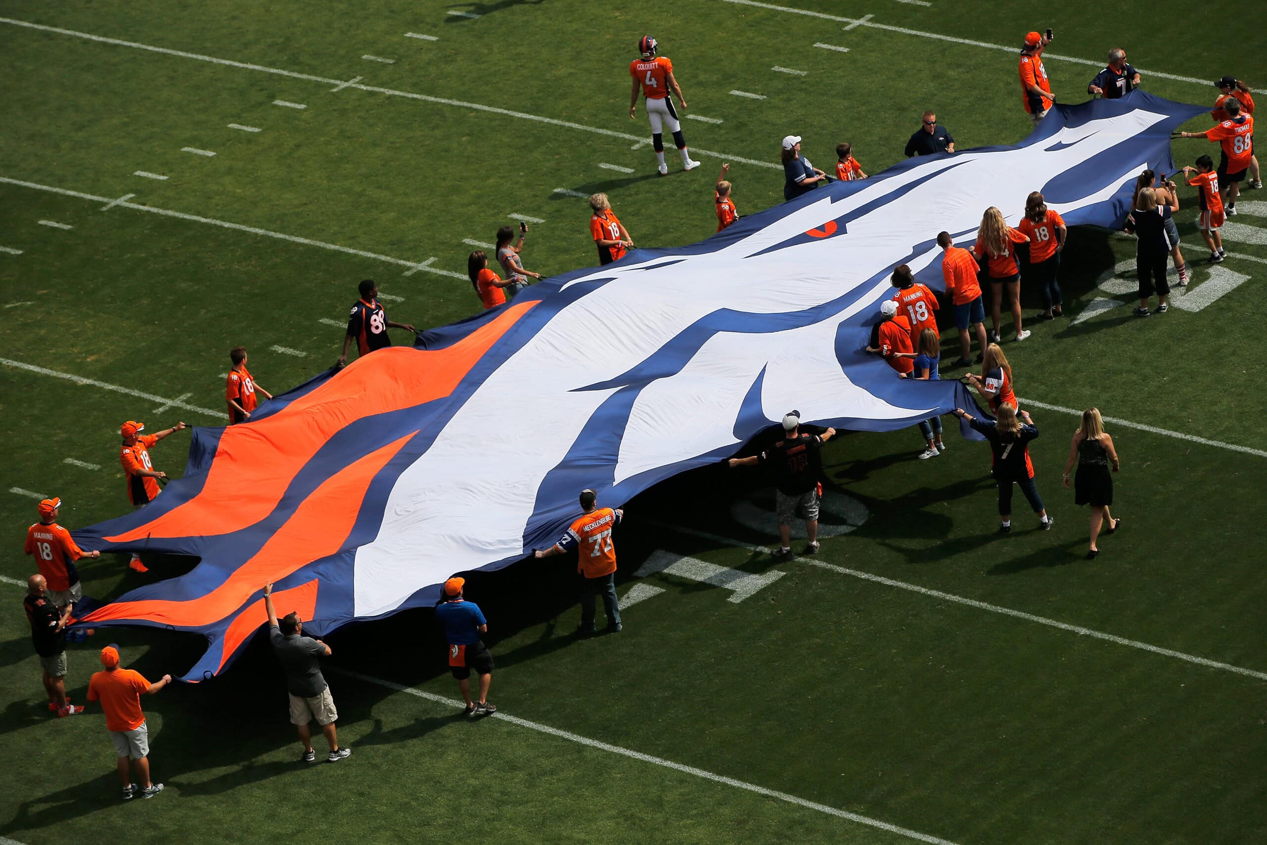 DENVER, CO - SEPTEMBER 13: Fans display a Denver Broncos flag on the field as the team hosts the Baltimore Ravens at Sports Authority Field at Mile High on September 13, 2015 in Denver, Colorado. The Broncos defeated the Ravens 19-13.