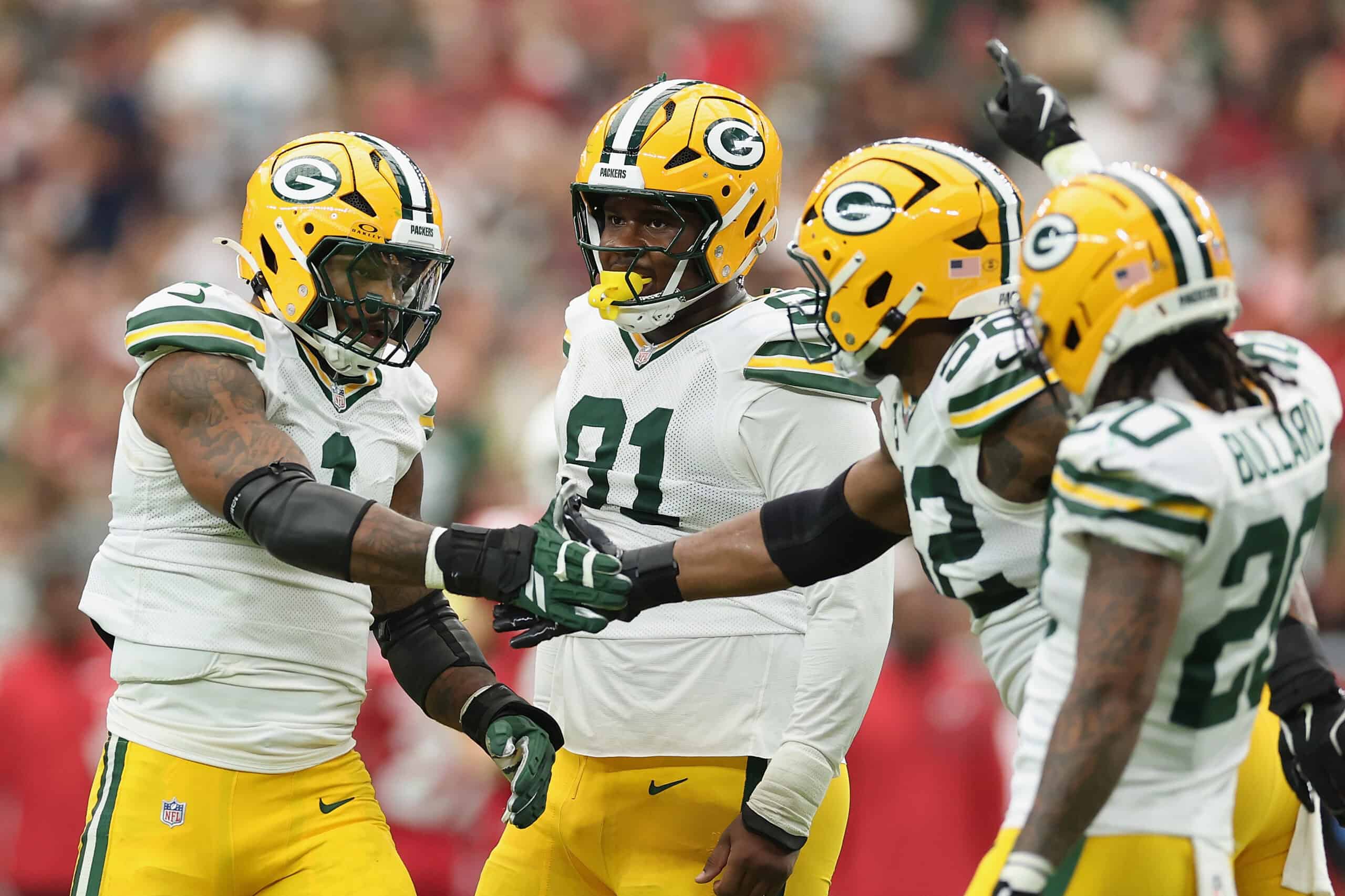 GLENDALE, ARIZONA - OCTOBER 19: Micah Parsons #1 of the Green Bay Packers celebrates a sack with Warren Brinson #91, Rashan Gary #52 and Javon Bullard #20 during the second quarter of the NFL game against the Arizona Cardinals at State Farm Stadium on October 19, 2025 in Glendale, Arizona. The Packers defeated the Cardinals 27-23.