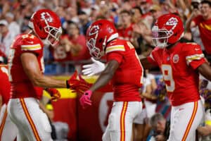 KANSAS CITY, MISSOURI - OCTOBER 12: Xavier Worthy #1 of the Kansas City Chiefs celebrates a touchdown against the Detroit Lions with teammates Travis Kelce #87 and Juju Smith-Schuster #9 during the first quarter in the game at Arrowhead Stadium on October 12, 2025 in Kansas City, Missouri.