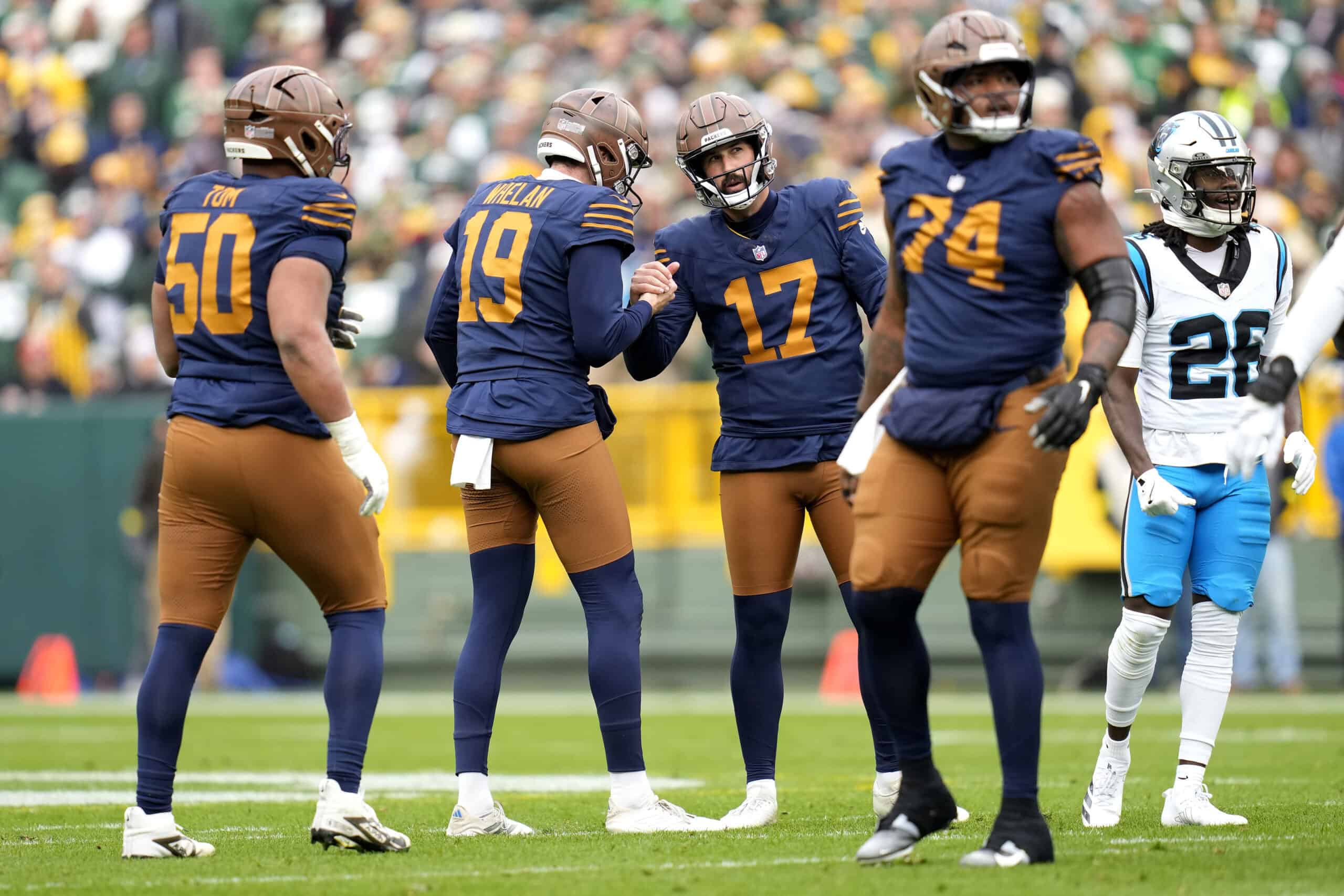 GREEN BAY, WISCONSIN - NOVEMBER 02: Brandon McManus #17 reacts with Daniel Whelan #19 of the Green Bay Packers in the game at Lambeau Field on November 02, 2025 in Green Bay, Wisconsin.