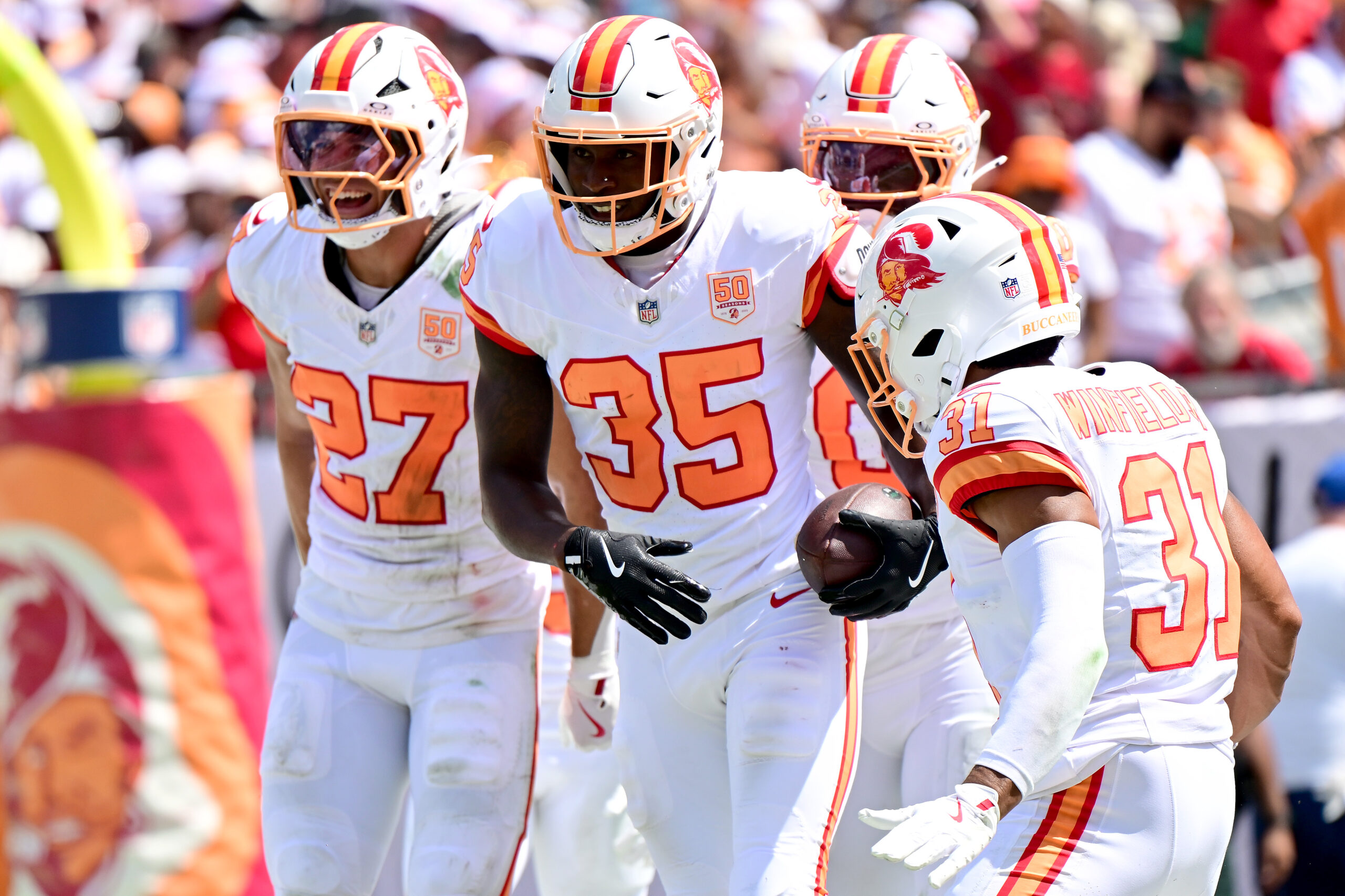 TAMPA, FLORIDA - SEPTEMBER 21: Jamel Dean #35 of the Tampa Bay Buccaneers celebrates with teammates after an interception for a touchdown during the second quarter against the New York Jets at Raymond James Stadium on September 21, 2025 in Tampa, Florida.