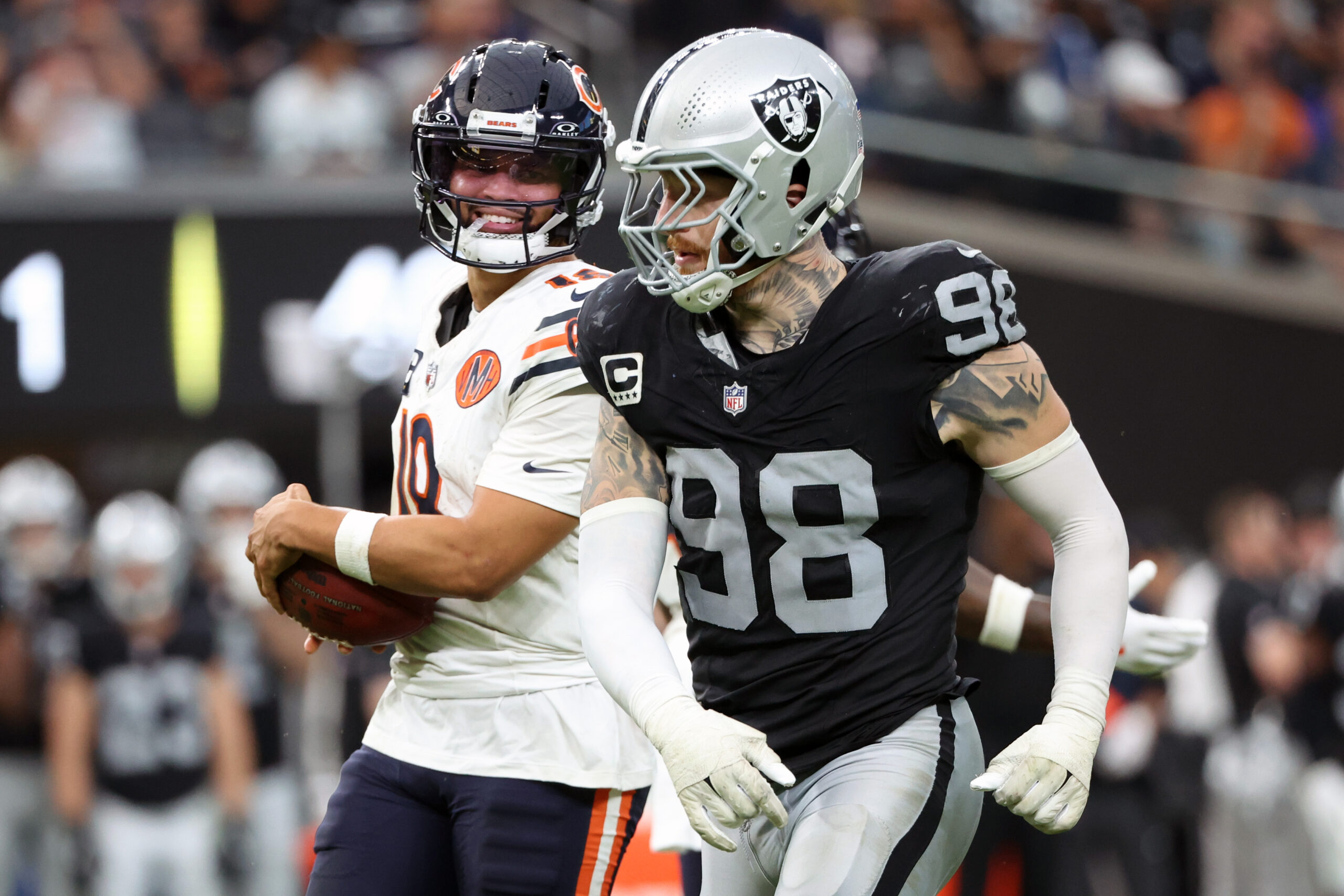 LAS VEGAS, NEVADA - SEPTEMBER 28: Caleb Williams #18 of the Chicago Bears smiles at Maxx Crosby #98 of the Las Vegas Raiders during the third quarter at Allegiant Stadium on September 28, 2025 in Las Vegas, Nevada.