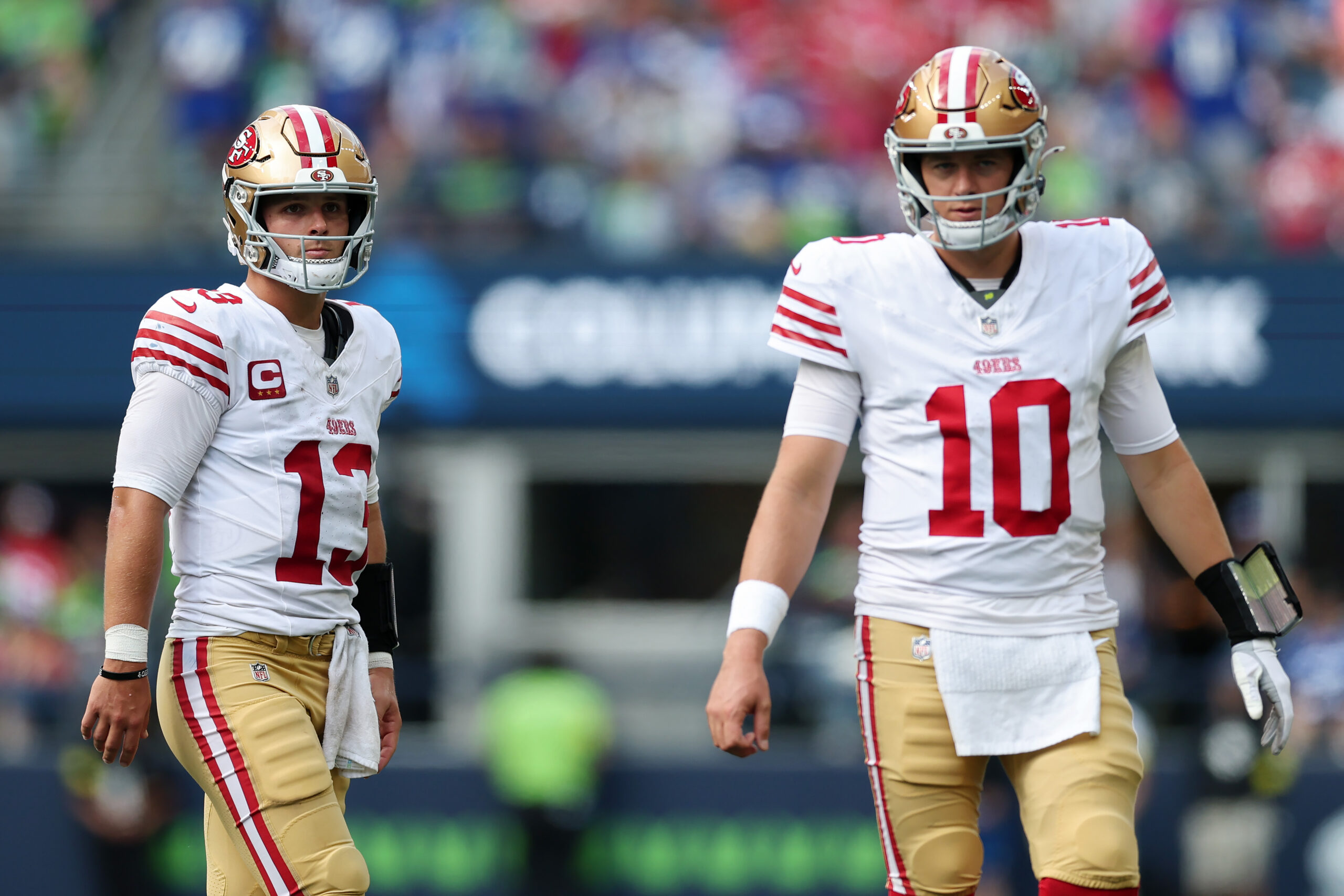 SEATTLE, WASHINGTON - SEPTEMBER 07: Brock Purdy #13 and Mac Jones #10 of the San Francisco 49ers looks on during the third quarter against the Seattle Seahawks during the game at Lumen Field on September 07, 2025 in Seattle, Washington.
