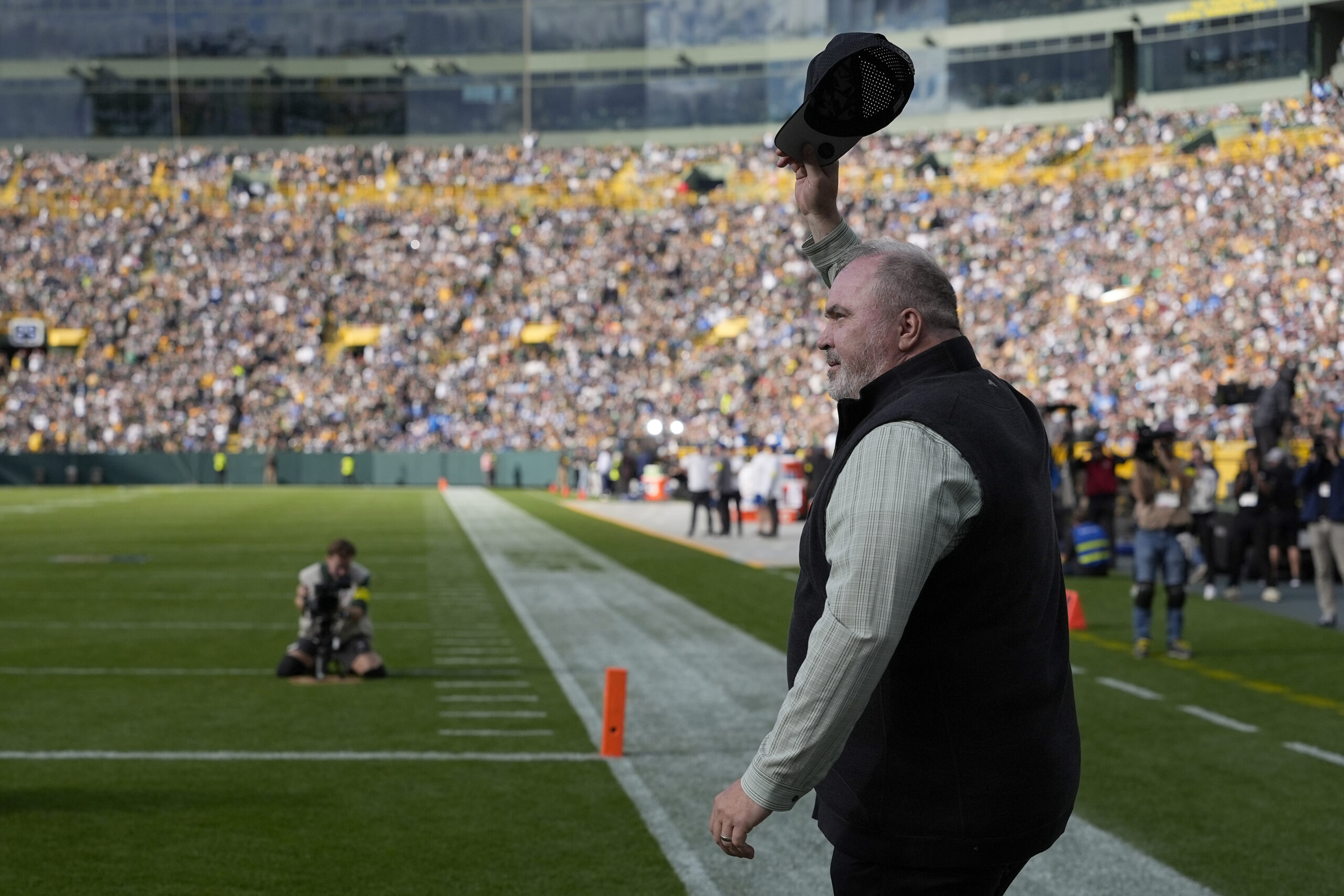 GREEN BAY, WISCONSIN - SEPTEMBER 07: Former Green Bay Packers head coach Mike McCarthy is honored during halftime of a game against the Detroit Lions at Lambeau Field on September 07, 2025 in Green Bay, Wisconsin.